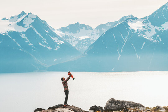 Father Holding Up Baby Hiking In Mountains Travel Family Adventure Lifestyle Vacations Dad With Kid Outdoor Journey In Norway