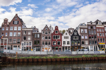 Amsterdam canal with typical dutch houses. Netherlands autumn cityscape.