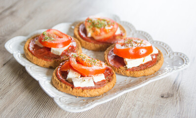 Bruschetta with tomato, cheese and onions on wooden table
