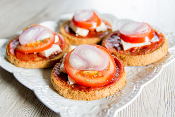 Bruschetta with tomato, cheese and onions