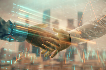 Double exposure of financial graph on cityscape background with two businessman handshake. Concept of stock market deal