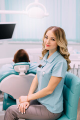 Fototapeta premium Portrait of young woman dentist at workplace