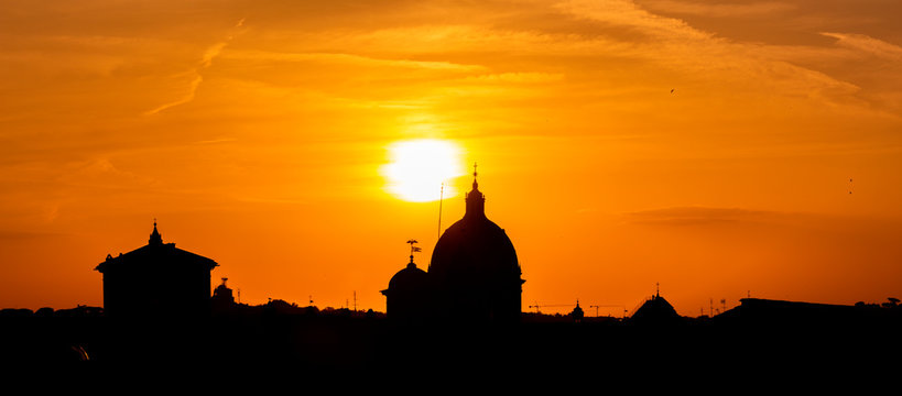 A Panoramic view of the roofs and Dome of Rome in silhouette at Sunset.Europe, Italy, Lazio Region, Province of Rome, Rome