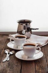 Coffee on a wooden table in white mugs