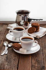 Coffee on a wooden table in white mugs