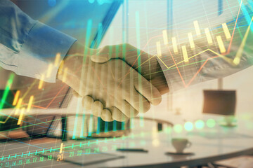 Multi exposure of financial graph on office background with two businessmen handshake. Concept of success in business