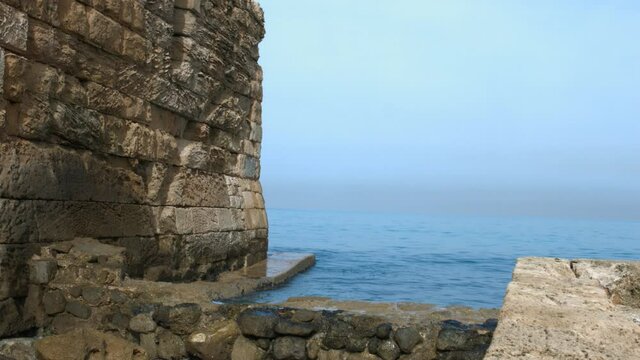 Waves breaking on walls of Sidon Sea Castle in Sidon, Lebanon