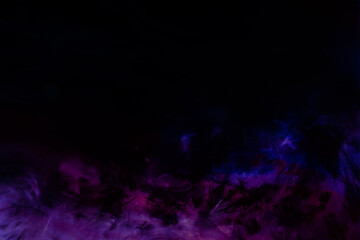 Beautiful abstract purple and blue feathers on the dark and black background and colorful soft black feather texture