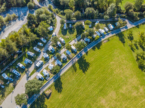 Aerial view of campground in rural area in Europe with many caravans. Concept of adventure and outdoor tourism in Europe.