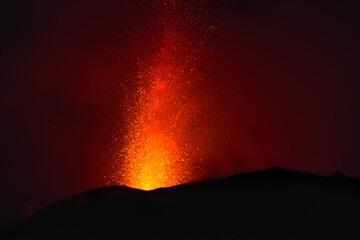 explosive eruption at dusk in one of the three craters of the active stromboli volcano, eolian...