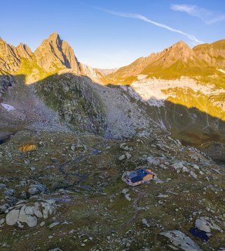 Aerial view at sunrise of the Pizzo Prevat and Capanna Leit. Rodi, Prato Leventina, Valle Leventina, Canton Ticino, Switzerland.