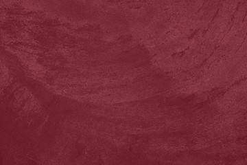 Dark red low contrast concrete textured wall background to your concept or product. Winter color trend.