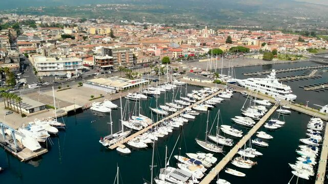 Aerial push in above boats in Marina di Riposto, Sicily Italy