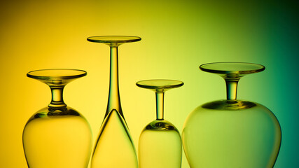 inverted glasses, legs of glasses on a colored background