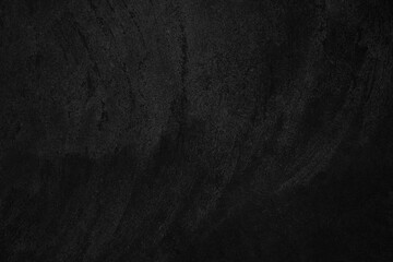 Black low contrast concrete textured wall background with roughness and irregularities to your...