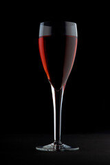 Red wine glass against a dark background