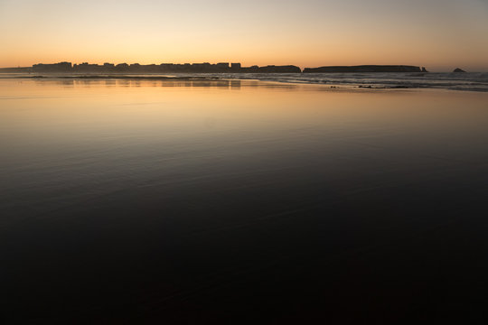 Sunset at Baleal beach with the baleal island in the background in Peniche, Atlantic coast of Portugal.