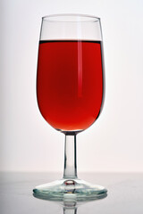 glass with red wine on a light background