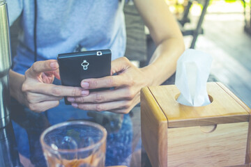 Today's working woman, she works outside the home. She is waiting for a call from the customer and checking the email.