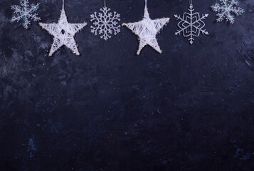 Hand made snowflakes on black shabby background, garland