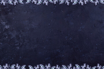 Black shabby background with texture around the edges of a snowflake.