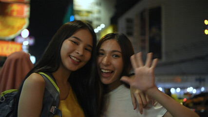 Travel concept. A group of beautiful women waving their hands to greet and smile happily. 4k Resolution.
