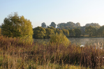 Beautiful landscape of autumn forest with a mountain lake.