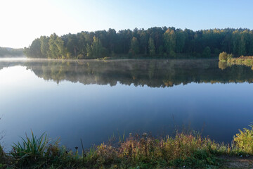 Beautiful landscape of autumn forest with a mountain lake.