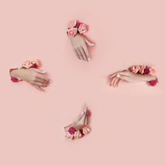 Obraz na płótnie Canvas Set hands with artificial flowers sticking out of hole pink paper background. Hand in various poses, the pattern layout for your collage. Cosmetics hand skin care, moisturizing and wrinkle reduction