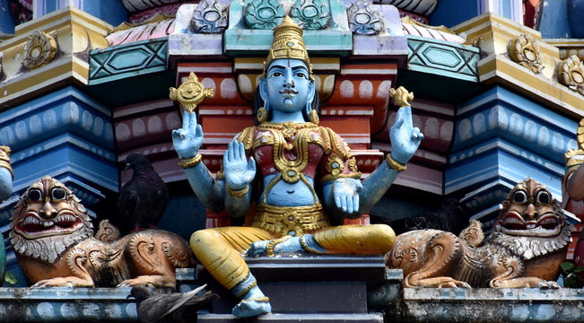 Beautiful god statue on the roof of a Hindu temple