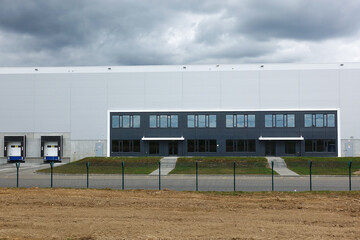 Fototapeta na wymiar Production building, warehouse. sky with thunderclouds.