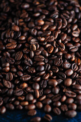 roasted aromatic coffee beans closeup sprinkled on a table