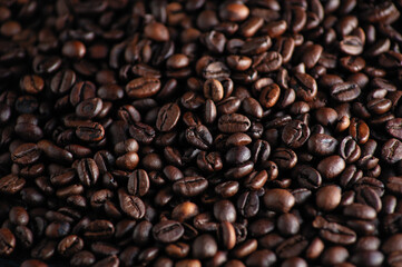 roasted aromatic coffee beans closeup sprinkled on a table