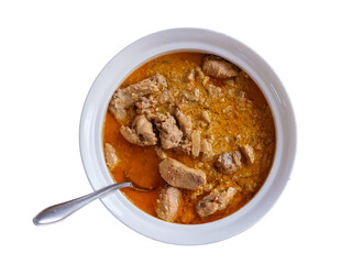 Georgian meal kharcho with beef, garlic tomato, walnuts and herbs in white bowl