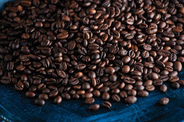 roasted aromatic coffee beans closeup sprinkled on a table
