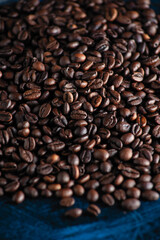 roasted aromatic coffee beans closeup sprinkled on a table