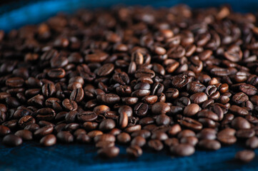 roasted aromatic coffee beans closeup sprinkled on a table