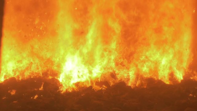 Looking inside an incinerator, in a factory. Burning fire.