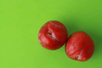 Delicious plums in colorful background
