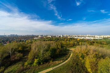 Fototapeta na wymiar The view on multi-storey houses and natural park residential areas of ​​Berlin from hill on the district of Marzahn-Hellersdorf.