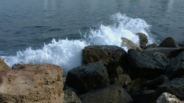 Waves breaking on rocks of Sidon Sea Castle in Sidon, Lebanon