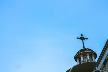 Fototapeta na wymiar Church dome with Christianity cross on the roof top 