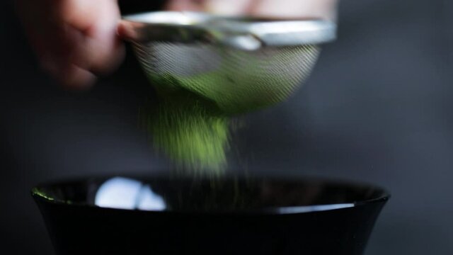 Matcha green tea is sift through a sieve