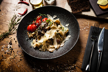 Black Angus Pasta served in a black bowl in restaurant