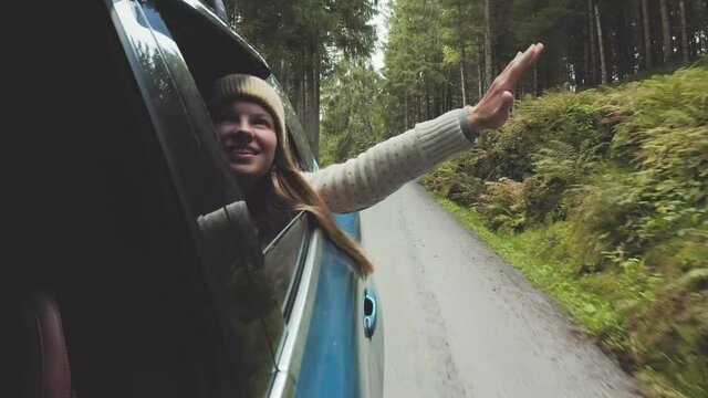 Woman traveling by rental car road trip in Norway adventure lifestyle vacations outdoor happy smiling girl positive emotions van life forest nature view