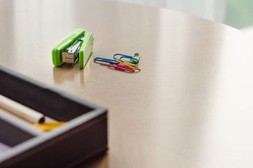 Green stapler and paper clip