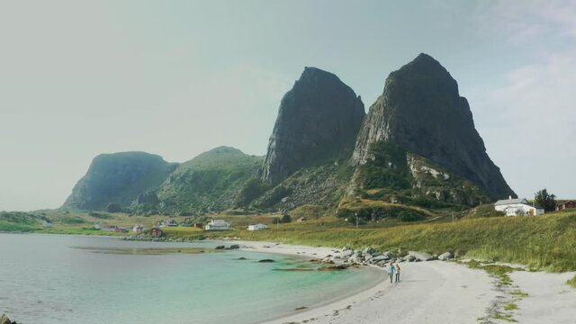 Family couple walking on beach travel lifestyle summer vacations outdoor in Norway man and woman with child relaxing enjoying sea vie aerial