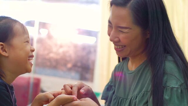 Happy loving family. Mother and her daughter child girl playing high five and hugging