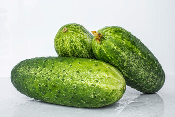 Composition of cucumber on a white background with reflection
