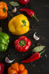 flat lay, chili pepper, dark background, dark brown wood, depth of field, food, fresh, green peppers, orange pepper, peppers, red pepper, shallow depth of field, vegetable, yellow pepper, flat lay